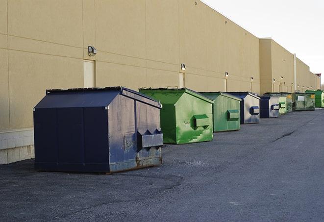 large construction dumpster positioned on a city street in Beaverton, MI